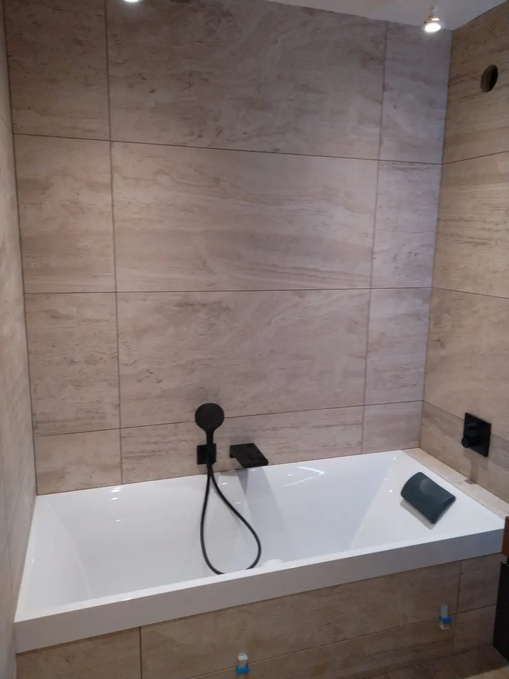Baignoire encastrée et murs en carrelage grand format